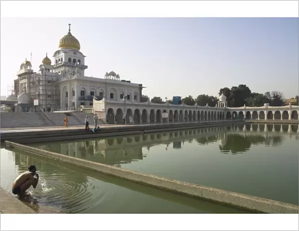 Sikh pilgrim bathing in the pool of the Gurudwara Bangla Sahib temple