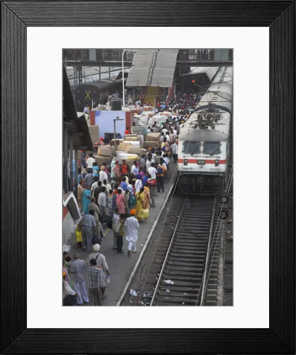 Framed Print : Train ariving at crowded platform in New Delhi train station Framed Print : Train ariving at crowded platform in New Delhi train station