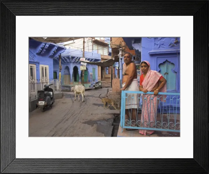 Framed Print : Couple standing outside blue painted residential haveli Framed Print : Couple standing outside blue painted residential haveli