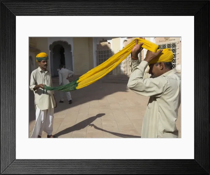 Framed Print : Guard winding his yellow and green turban
