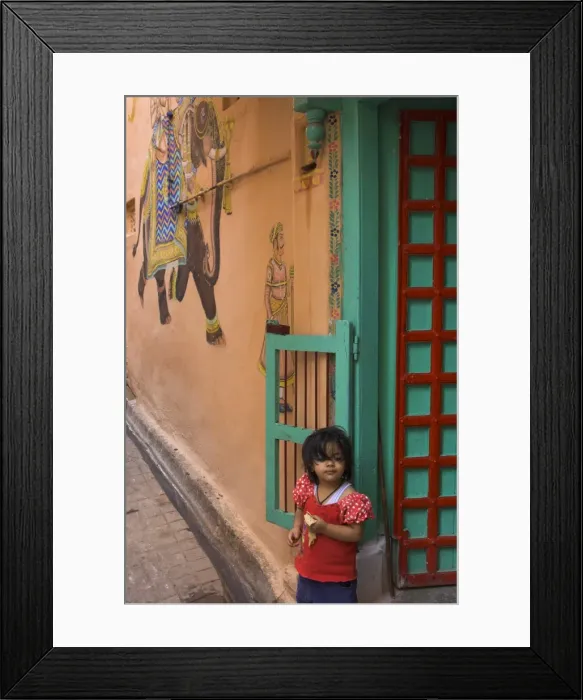 Framed Print : Small girl standing in doorway of typical house decorated Framed Print : Small girl standing in doorway of typical house decorated