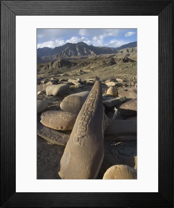 Framed Print : Close up of traditional carved prayer stones on a prayer Framed Print : Close up of traditional carved prayer stones on a prayer