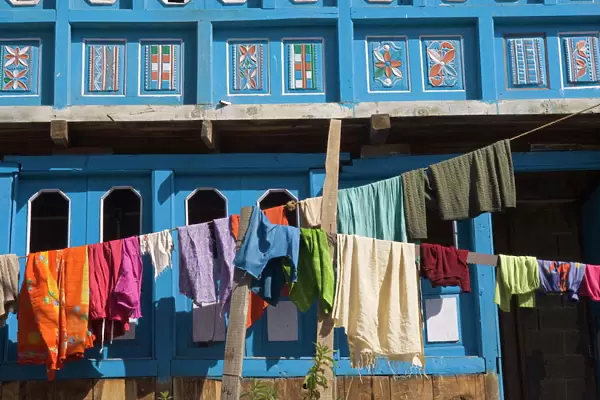 Close up of colourful laundry hanging in front of blue