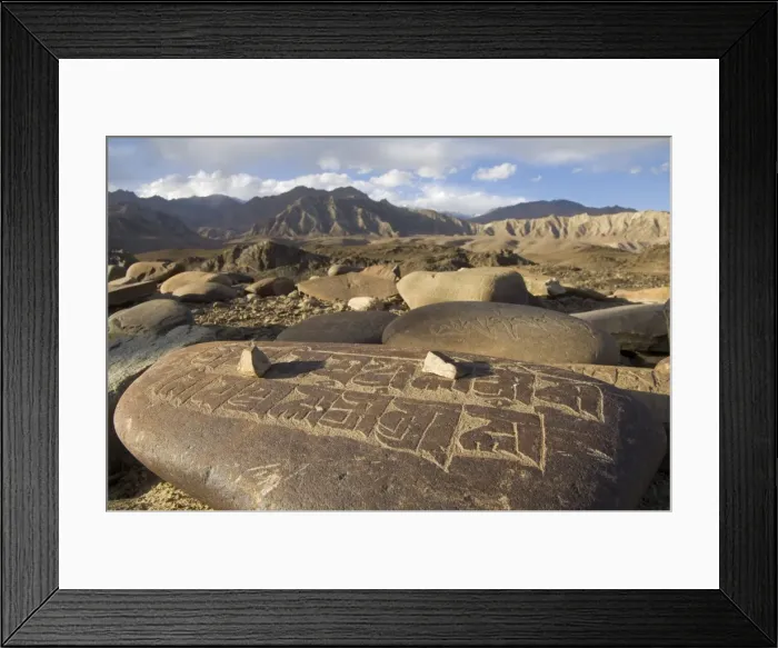 Framed Print : Close up of traditional carved prayer stones on a prayer Framed Print : Close up of traditional carved prayer stones on a prayer
