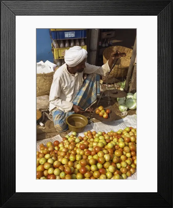 Framed Print : Man weighing tomatoes on scales Framed Print : Man weighing tomatoes on scales