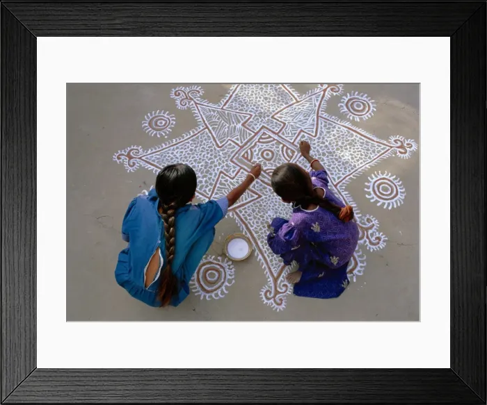 Framed Print : Women painting a Mandana on the ground Framed Print : Women painting a Mandana on the ground