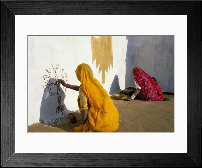 Framed Print : Women painting design on a wall in a village near Jaisalmer Framed Print : Women painting design on a wall in a village near Jaisalmer