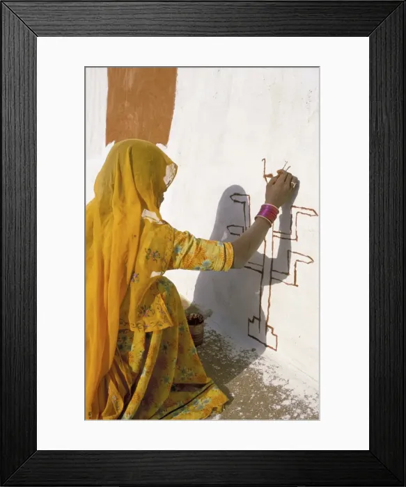Framed Print : Woman painting design on a wall in a village near Jaisalmer Framed Print : Woman painting design on a wall in a village near Jaisalmer