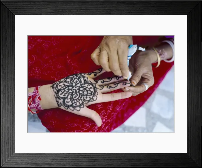Framed Print : Henna designs being applied to a womans hand Framed Print : Henna designs being applied to a womans hand