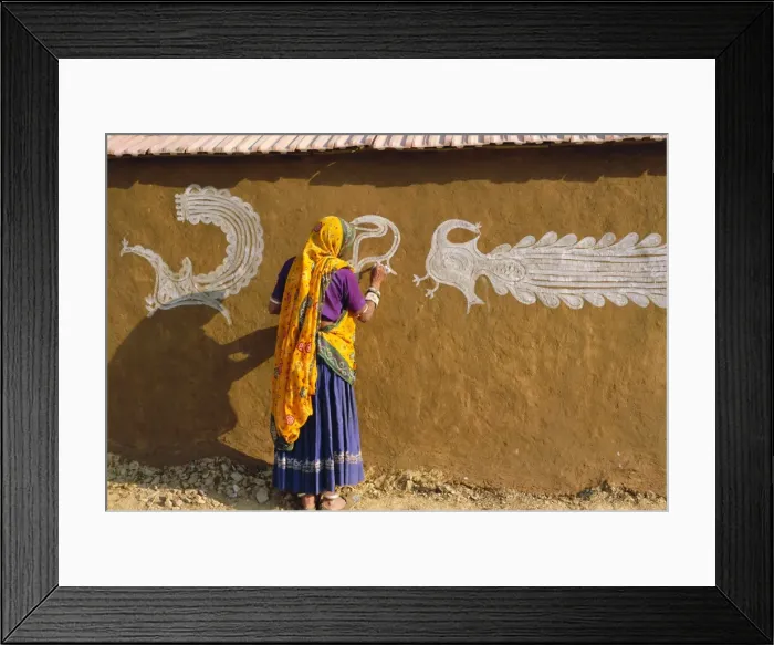 Framed Print : Woman decorating her house with traditional local designs Framed Print : Woman decorating her house with traditional local designs