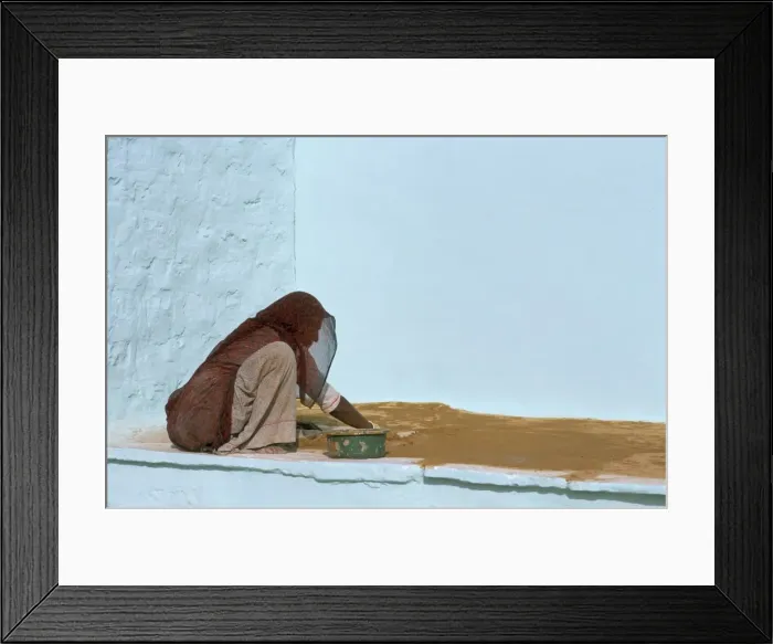 Framed Print : Woman painting walls in a village in the Barmer area Framed Print : Woman painting walls in a village in the Barmer area