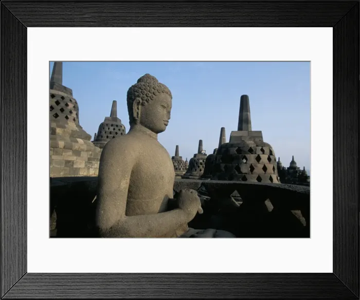 Framed Print : Buddha image sitting in open chamber with stupas in background Framed Print : Buddha image sitting in open chamber with stupas in background