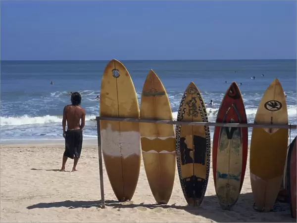 A line of surfboards waiting for hire at Kuta beach
