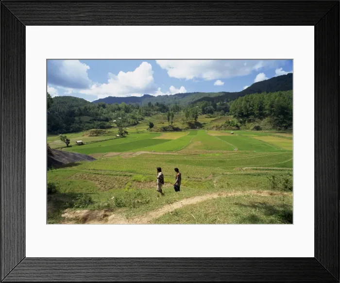 Framed Print : Agricultural landscape with two figures walking through fields Framed Print : Agricultural landscape with two figures walking through fields