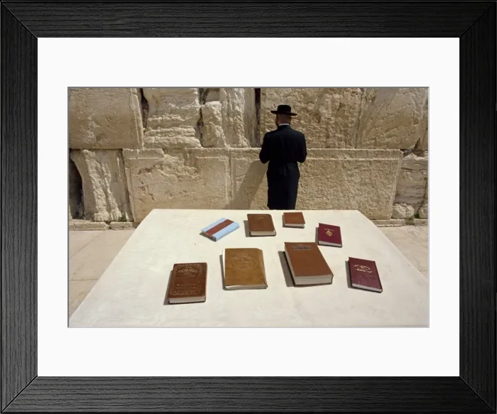 Framed Print : Religious books on table and Jewish man facing the Western Wall Framed Print : Religious books on table and Jewish man facing the Western Wall