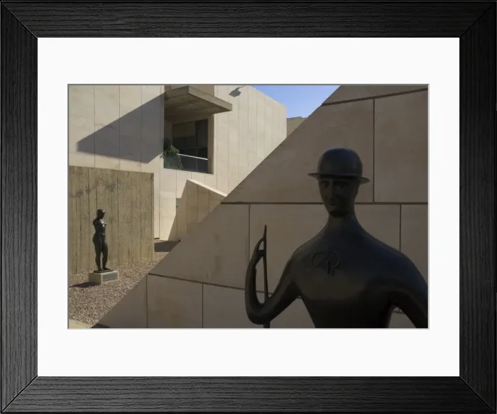 Framed Print : Two sculptures in front of geometrical walls of museum facade Framed Print : Two sculptures in front of geometrical walls of museum facade
