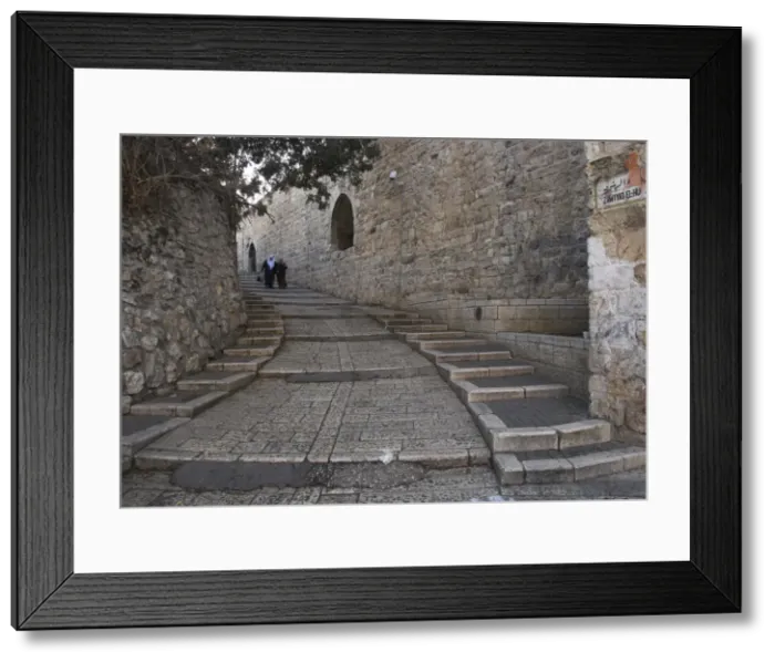 Framed Print : Two Palestinian women walking down a street along the city walls Framed Print : Two Palestinian women walking down a street along the city walls