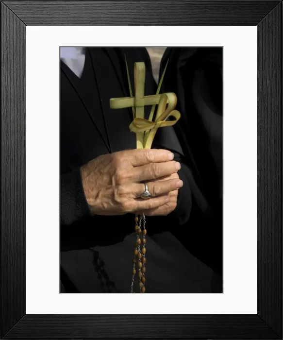 Framed Print : Close up of a nuns hands holding two crosses made of palm leaves Framed Print : Close up of a nuns hands holding two crosses made of palm leaves