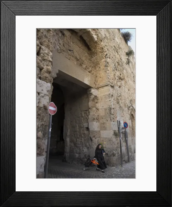 Framed Print : Woman walking out of old city through Zion Gate Framed Print : Woman walking out of old city through Zion Gate