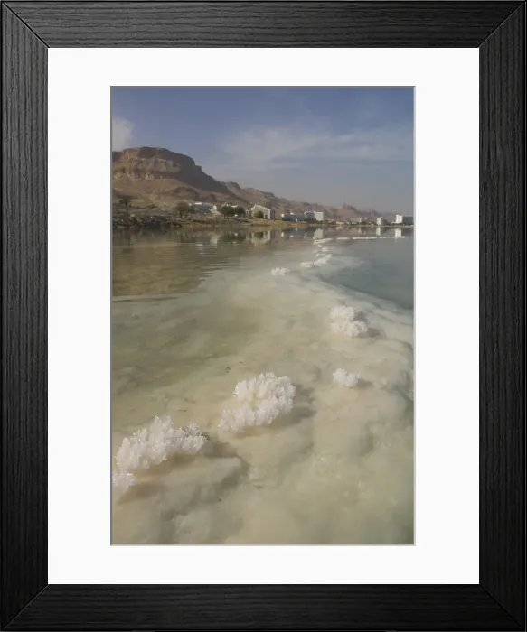 Framed Print : Sea and salt formations with hotels and desert cliffs beyond Framed Print : Sea and salt formations with hotels and desert cliffs beyond