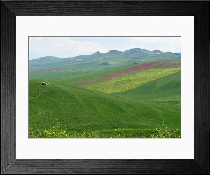 Framed Print : Fields and rolling hills in a typical landscape near Framed Print : Fields and rolling hills in a typical landscape near