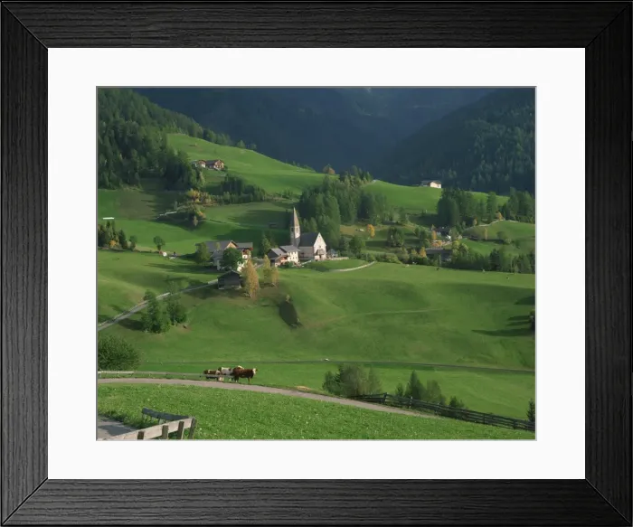 Framed Print : Church, houses and farmland in the Val di Funes in the Dolomites Framed Print : Church, houses and farmland in the Val di Funes in the Dolomites