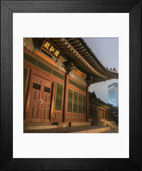 Framed Print : Deoksugung Palace, traditional Korean building, illuminated at dusk, with modern Framed Print : Deoksugung Palace, traditional Korean building, illuminated at dusk, with modern