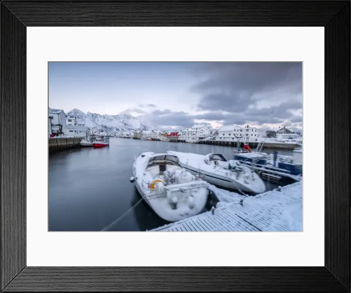 Framed Print : The typical fishing village of Henningsvaer surrounded by snow capped mountains and the cold sea Framed Print : The typical fishing village of Henningsvaer surrounded by snow capped mountains and the cold sea
