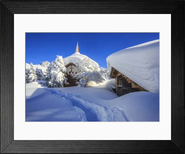 Framed Print : The small church and the house submerged by snow after a heavy snowfall in Maloja Framed Print : The small church and the house submerged by snow after a heavy snowfall in Maloja