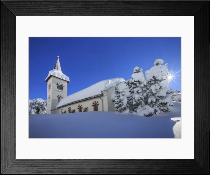 Framed Print : Rays of winter sun illuminate the snowy landscape and the typical church, Maloja Framed Print : Rays of winter sun illuminate the snowy landscape and the typical church, Maloja