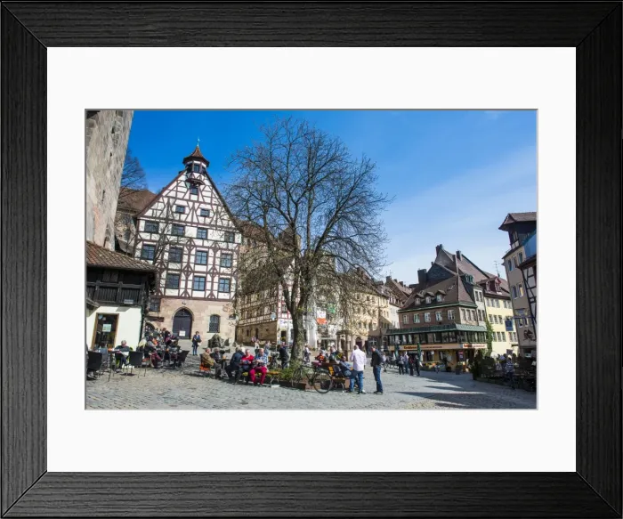 Framed Print : Half timbered houses and open air cafes on Albrecht Duerer square in the medieval Framed Print : Half timbered houses and open air cafes on Albrecht Duerer square in the medieval