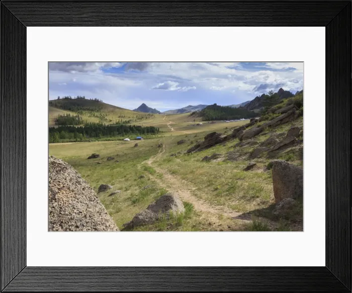 Framed Print : Path winds past hills and tourist ger camp towards distant mountains in summer, Terelj Framed Print : Path winds past hills and tourist ger camp towards distant mountains in summer, Terelj