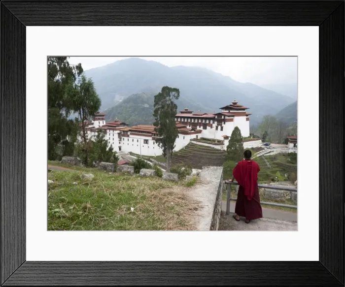 Framed Print : Buddhist monk looking back at Trongsa Dzong, Bhutans largest monastery fortress Framed Print : Buddhist monk looking back at Trongsa Dzong, Bhutans largest monastery fortress