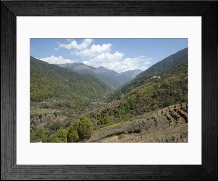 Framed Print : View through farmland clinging to the Himalayan foothills towards China from Wangdue Framed Print : View through farmland clinging to the Himalayan foothills towards China from Wangdue