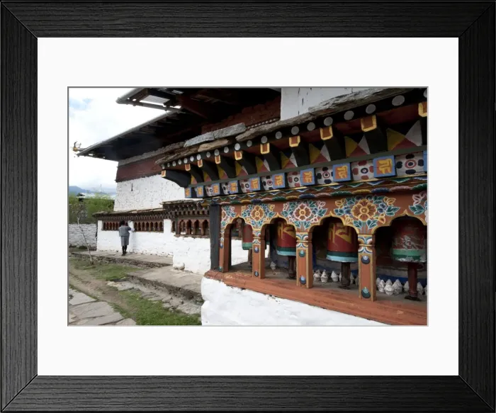 Framed Print : Buddhist man spinning temple prayer wheels outside Dumtse Lakhang Buddhist temple Framed Print : Buddhist man spinning temple prayer wheels outside Dumtse Lakhang Buddhist temple