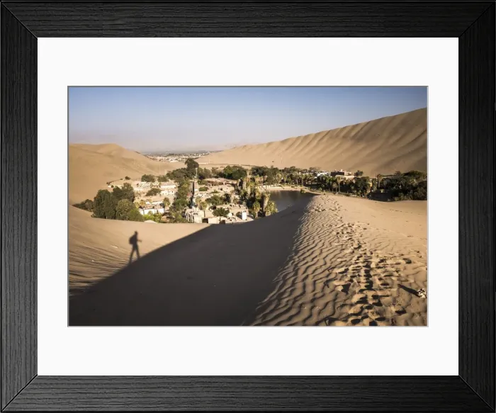 Framed Print : Climbing sand dunes at sunset at Huacachina, a village in the desert, Ica Region