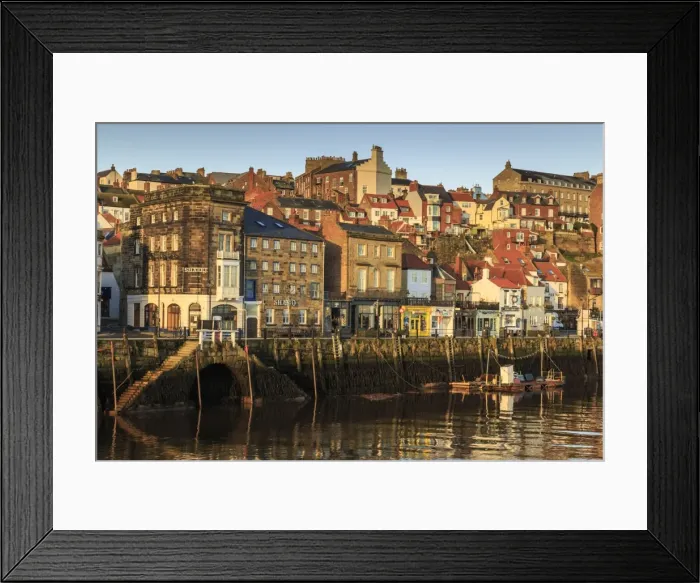Framed Print : Townhouses, bars and restaurants on Pier Road, West Side of River Esk, lit by low sun in winter Framed Print : Townhouses, bars and restaurants on Pier Road, West Side of River Esk, lit by low sun in winter