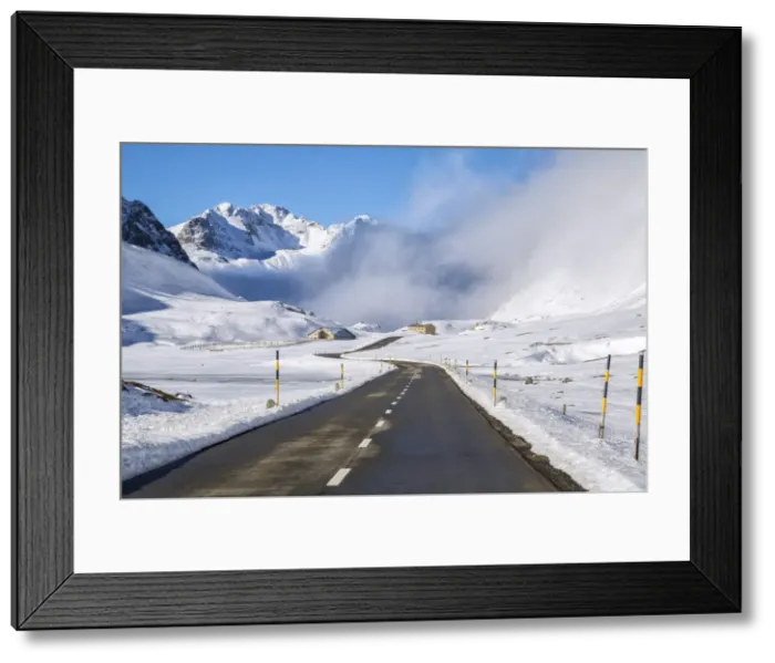 Framed Print : The road runs through the snow covered valley, Albula Pass, Engadine, Graubunden Framed Print : The road runs through the snow covered valley, Albula Pass, Engadine, Graubunden