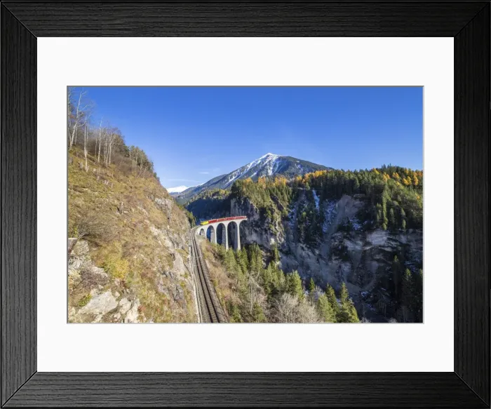 Framed Print : Bernina Express passes over the Landwasser Viadukt surrounded by colorful woods Framed Print : Bernina Express passes over the Landwasser Viadukt surrounded by colorful woods
