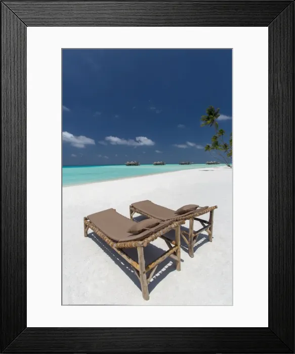 Framed Print : Lounge chairs and tropical beach, water villas and palm trees, Maldives, Indian Ocean Framed Print : Lounge chairs and tropical beach, water villas and palm trees, Maldives, Indian Ocean
