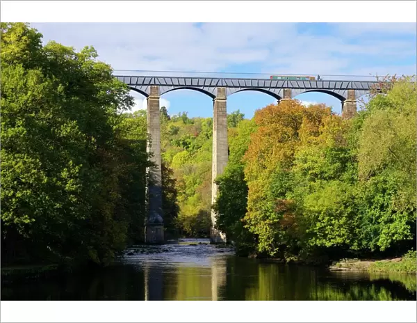 Narrowboat crossing the River Dee in autumn on the Pontcysyllte Aqueduct, built by Thomas Telford
