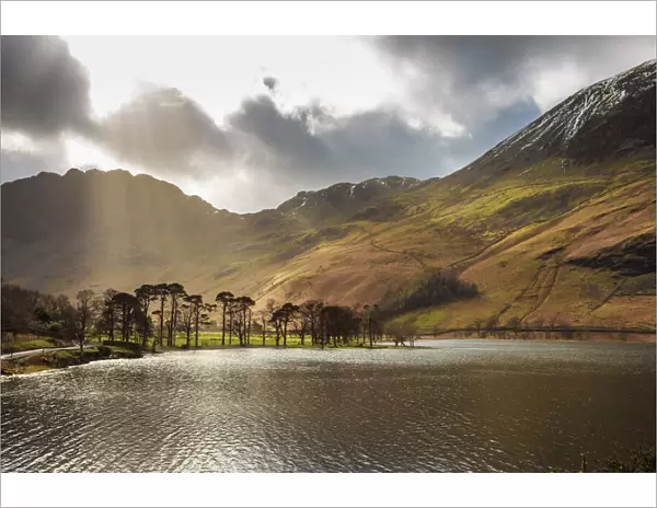 Shafts of light break through clouds to illuminate the fells in winter, Buttermere