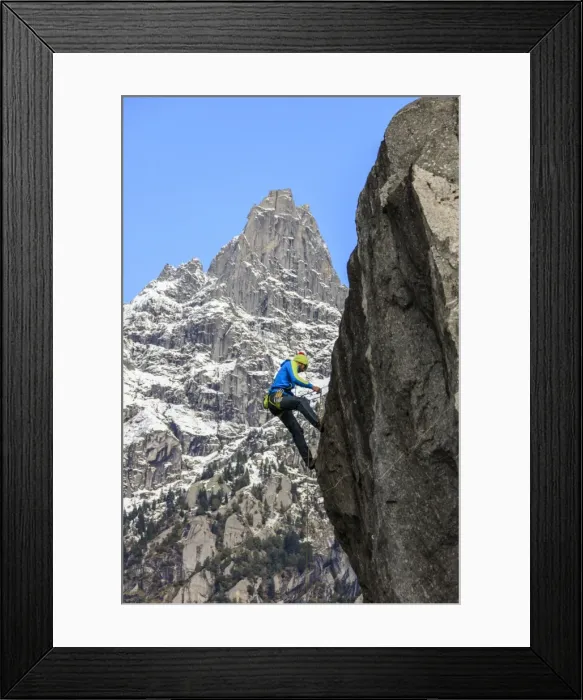 Framed Print : Climber on steep rock face in the background blue sky and peaks of the Alps, Masino Valley Framed Print : Climber on steep rock face in the background blue sky and peaks of the Alps, Masino Valley