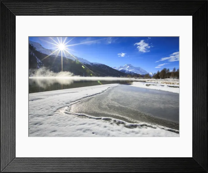 Framed Print : Rays of winter sun illuminate Lake Silvaplana still partially frozen, Maloja, Engadine Framed Print : Rays of winter sun illuminate Lake Silvaplana still partially frozen, Maloja, Engadine