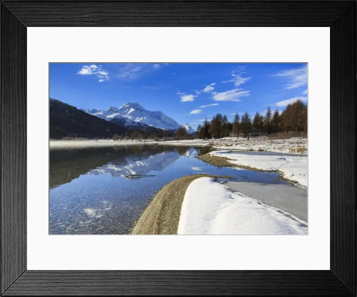 Framed Print : Snowy peaks are reflected in Lake Silvaplana still partially frozen, Maloja, Canton of Graubunden Framed Print : Snowy peaks are reflected in Lake Silvaplana still partially frozen, Maloja, Canton of Graubunden