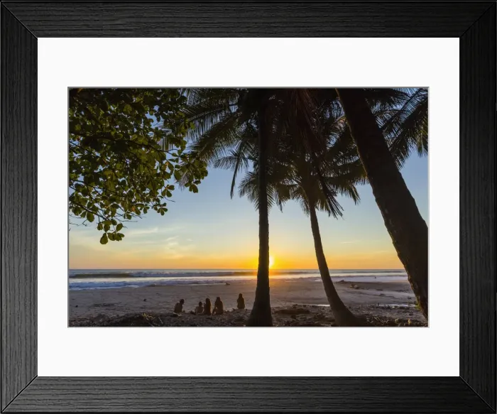 Framed Print : People by palm trees at sunset on Playa Hermosa beach, far south of the Nicoya Peninsula Framed Print : People by palm trees at sunset on Playa Hermosa beach, far south of the Nicoya Peninsula