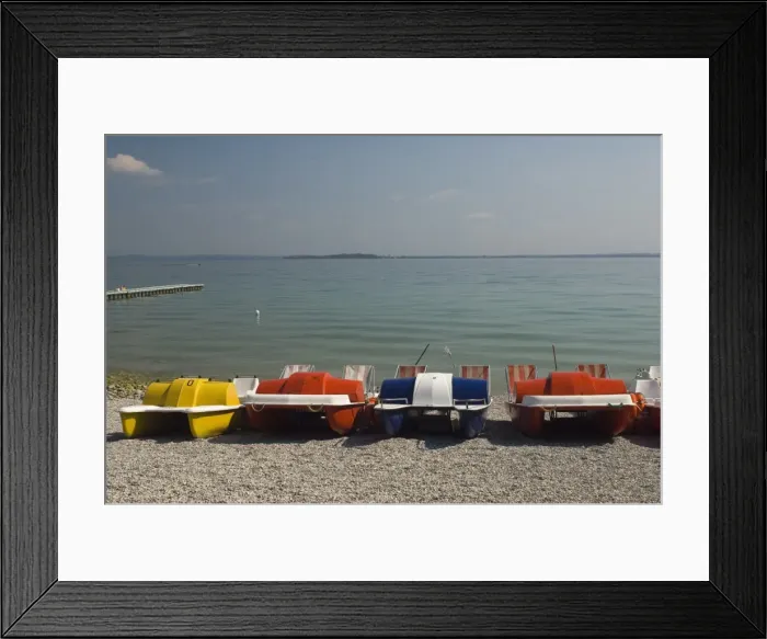 Framed Print : Pedalos on the beach at Monega del Garda