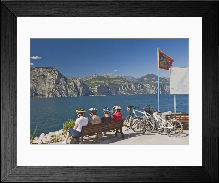 Framed Print : Four cyclists resting by Lake Garda Framed Print : Four cyclists resting by Lake Garda