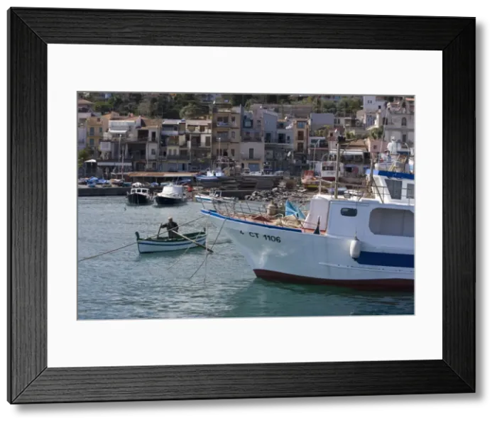 Framed Print : Man rowing a traditional fishing boat in the harbour Framed Print : Man rowing a traditional fishing boat in the harbour