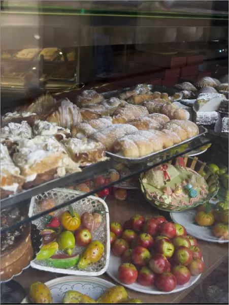Traditional marzipan fruits and pastries in shop window